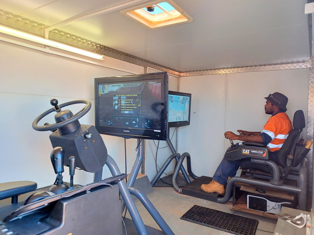 The two simulators, with Kasman Spencer concentrating on the excavator simulator.