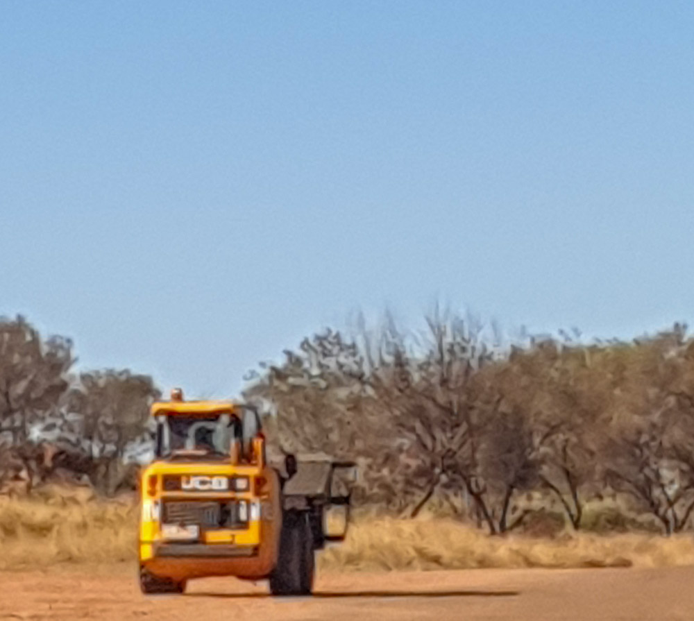 The skid steer with the spreader bar at work.