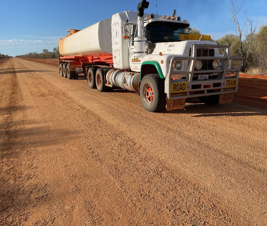 Rolling the road with a loaded 20,000L water truck.