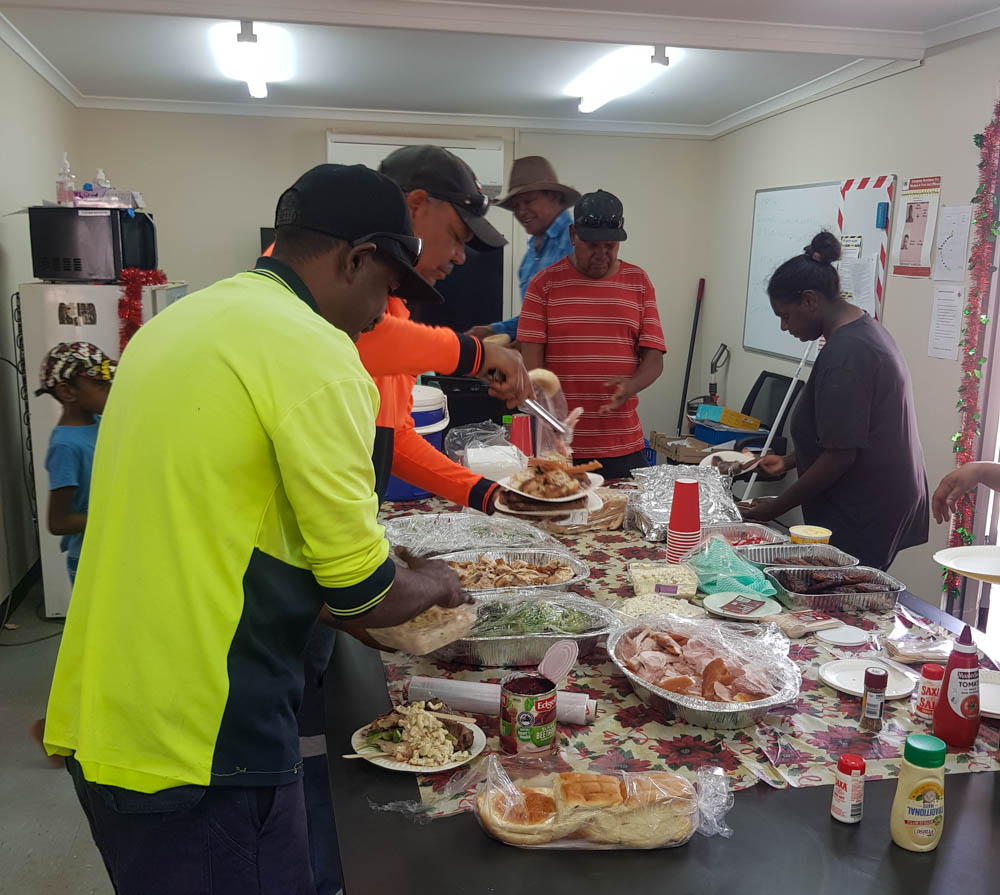Staff digging in to the Christmas lunch in Yuelamu.