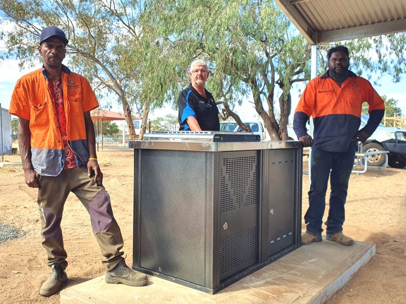 Nathan Fishook, Scott Pinchbeck and Shane White with the barbecue at the Atitjere basketball court